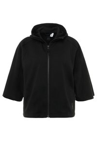 Černá fleecová bunda s kapucí, krátkými rukávy, plným zipem a volným střihem. Má příjemný povrch a minimalistický design.