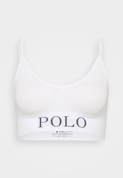 White bralette with thin straps, ribbed texture, and a wide band featuring "POLO" in navy blue. Simple, modern design suitable for casual wear.