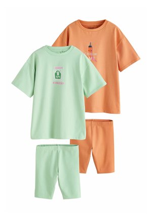 Two sets of children's short-sleeve tops and matching shorts, one light green with kimchi graphic, one orange with chili bottle graphic and "Chillin Out" text.