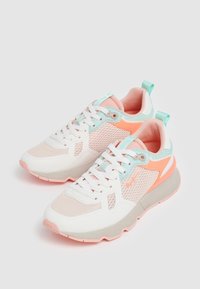 Athletic shoes featuring a white mesh upper with pastel pink, blue, and orange accents. Thick sole and lace-up design for support.