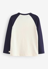 Langarmshirt met een crèmekleurig lichaam en marineblauwe raglanmouwen. Zachte katoenmaterialen met een ronde halslijn en een merklabel aan de zoom.