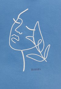 Tessuto blu con ricami bianchi che raffigurano un volto e foglie. La scritta "MiRONS" è ricamata sotto il disegno.