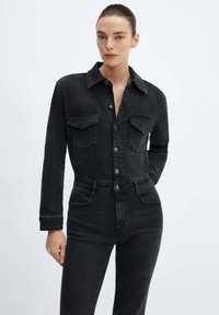 Črn jeans jakna z dvema prsni žepoma, gumbom spredaj in ovratnikom. V kombinaciji z visokim pasom črnimi kavbojkami, gladka tekstura, oprijet dizajn.