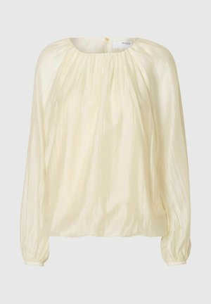 Vaalean kermanvärinen pusero, jossa on kerätty kaula-aukko, pitkät pullistuvat hihat ja hieman kiiltävä pinta. Yksinkertainen muotoilu ilman näkyviä kuvioita.