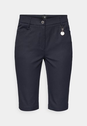 Tumesinised Bermuda lühikesed püksid, mis on valmistatud venivast kangast, ees lukuga, kahe külgtaskuga ja väike logo silt vöökoha peal.