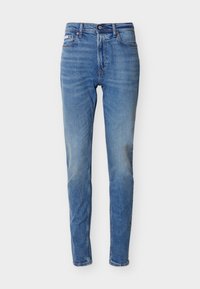 Τζιν μεσαίου μπλε χρώματος, στενή εφαρμογή, ψηλή μέση, με εμπρόσθιο κουμπί και φερμουάρ, σχεδιασμό με πέντε τσέπες και διακριτική ξεθώριαση στους μηρούς και τα γόνατα.