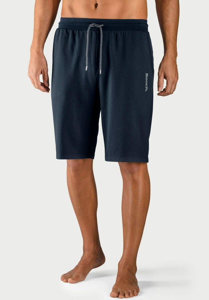 Marineblauwe shorts van zachte stof, met een elastische tailleband en trekkoord, en een subtiele logodetail aan de zijkant.