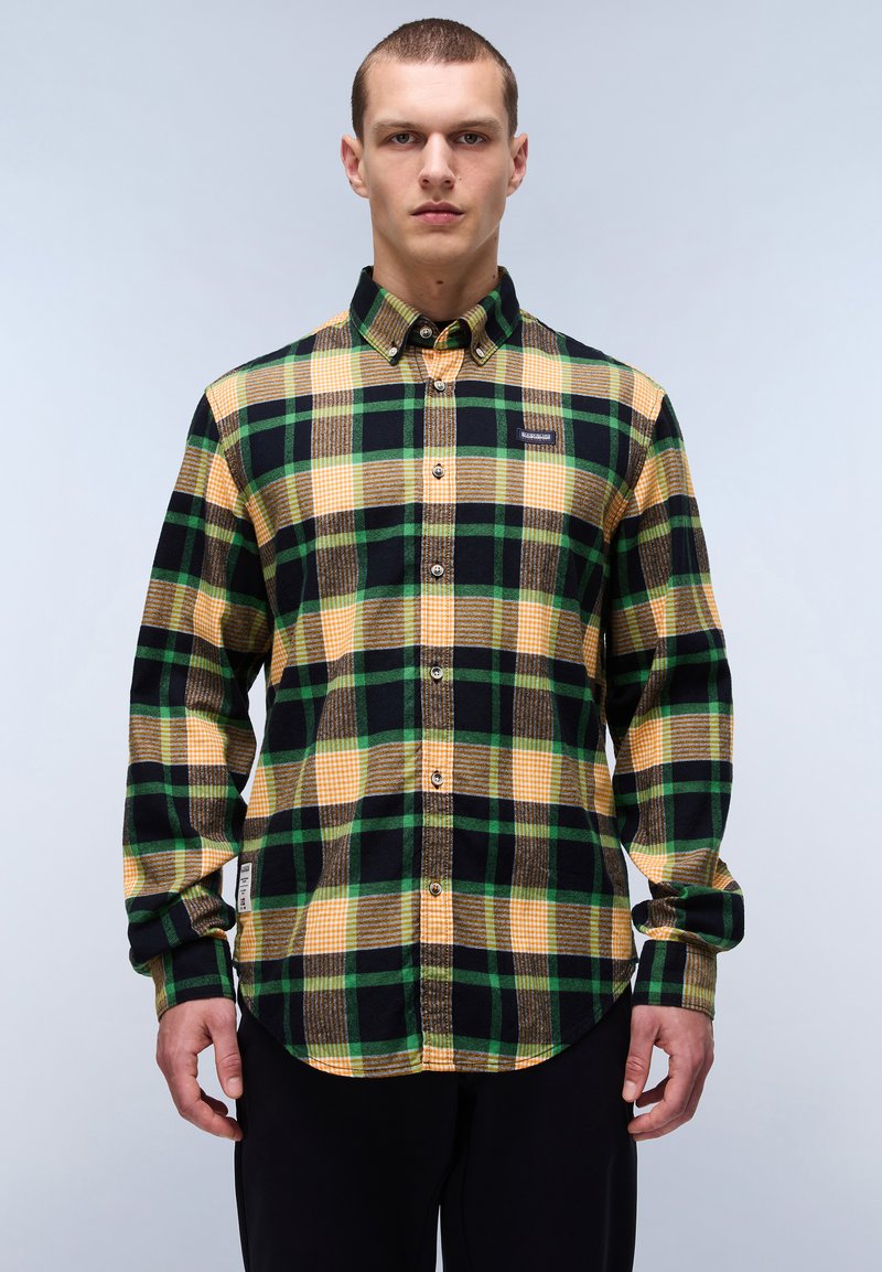 Knopen-overhemd van plaid met een geblokt patroon in groen, zwart en geel, gemaakt van flanelstof met een label op de borst.