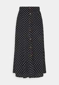 Punktskjorta i midi-längd i svart tyg med vita prickar. Den har en knäppning framtill med träknappar och en utställd design.