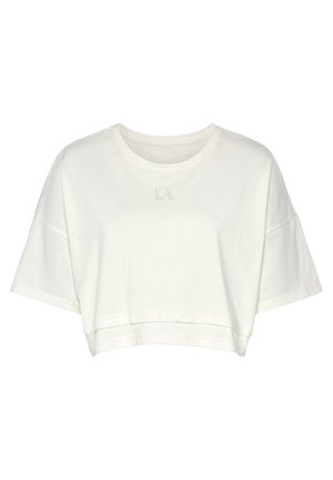 T-shirt cropped blanc en coton, avec des manches courtes, un col rond, et "LA" brodé au centre. Texture douce, design minimal.