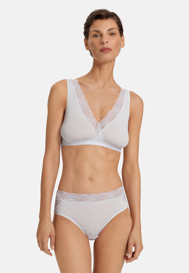 Bílý bavlněný bralet s krajkovým lemováním výstřihu, s bezšvým provedením a sladěnými vysokými kalhotkami, oboje s jemnými texturovanými detaily.