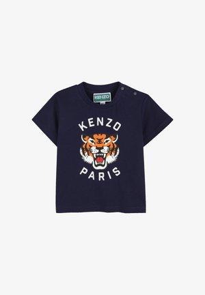T-shirt a maniche corte blu navy con una grafica di una tigre arricchita da accenti arancioni e bianchi, con la scritta "KENZO PARIS" sotto il motivo. Dettaglio con bottoni automatici.