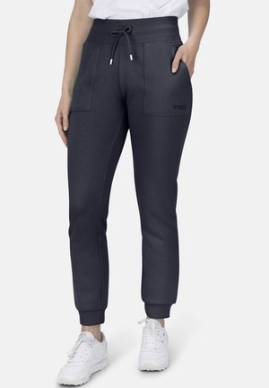 Marineblaue Sweatpants mit einem Kordelzugbund, zwei Vorderaschen, gerippten Bündchen und einem Logo-Detail am linken Oberschenkel. Geeignet für Sportbekleidung.