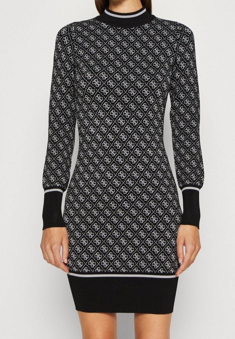 Robe noire à manches longues avec motifs losanges blancs, col et poignets côtelés, coupe ajustée, longueur genou, tissu en maille texturé.