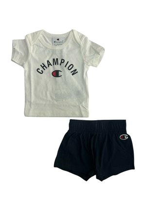 Maglia bianca Champion a maniche corte per neonati con logo e pantaloncini neri elasticizzati con piccolo logo Champion sulla gamba sinistra.