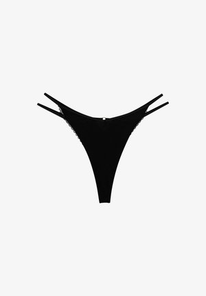 Black thong with thin straps and lace trim. Features a small metallic accent at the back. Smooth fabric with a minimalist design.