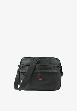 Black messenger bag with textured fabric, adjustable strap, two zippered compartments, and a red logo detail on the front.