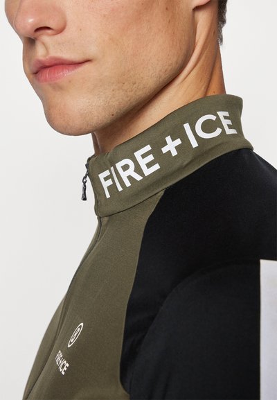 Zippered jacket in olive green and black, featuring a high collar with "FIRE + ICE" in bold white lettering. Smooth and fitted design.