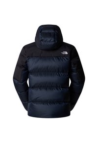 Doudoune bleu marine avec capuche, présentant une partie supérieure noire contrastante et un matelassage horizontal. Comprend un logo sur l'épaule.