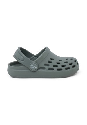 Molded green plastic clogs with cut-out ventilation holes, a rear strap, and a circular logo on the side. Smooth texture, lightweight design.