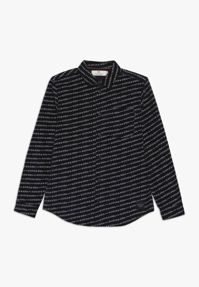 Chemise noire à manches longues avec un motif de texte blanc répété indiquant "SCOTCH & SODA." Design à col avec un ourlet arrondi.