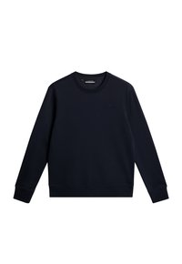 Mörk marinblå crewneck sweatshirt gjord av mjukt tyg. Har ribbade ärmslut och fåll, med en subtil logotypdetalj på bröstet.