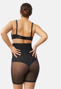 Shapewear negro de talle alto con paneles de malla transparente, que cuenta con tirantes ajustables y un cierre de gancho y ojo en la parte posterior.