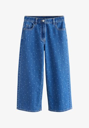 Blå denim vidde-benet jeans med hvide polkaprikker, forreste knap og lynlås, bæltestropper samt forlommer og møntlomme.