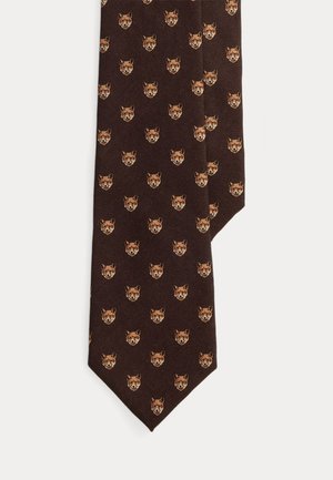 Cravate marron à motif de petites illustrations répétées de têtes de renard dans des nuances de beige et d’orange.