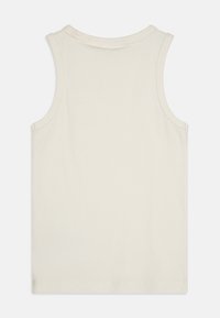 Top senza maniche color crema realizzato in tessuto a costine, con scollo rotondo e fondo dritto. Nessun motivo o hardware visibile.
