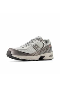 White and grey athletic shoe with mesh upper, silver accents, padded collar, and rubber outsole. Features laces and reinforced toe cap.