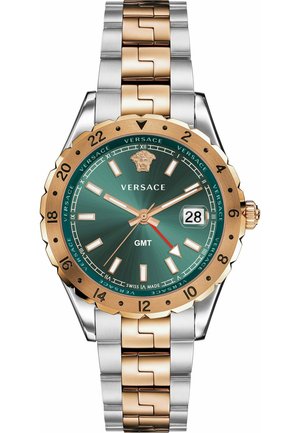 Versace GMT watch featuring a green dial, gold-tone bezel, silver and gold-tone link bracelet, and date display at three o'clock.