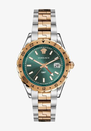 Versace GMT watch featuring a green dial, gold-tone bezel, silver and gold-tone link bracelet, and date display at three o'clock.