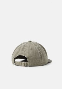 Olive green cotton baseball cap shown from the back with adjustable metal buckle strap on a white background.