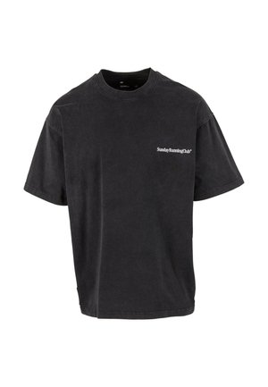 Sort oversized t-shirt lavet af bomuld, med rund hals og korte ærmer. Foran til venstre vises "SundayRunningClub" i hvid tekst.