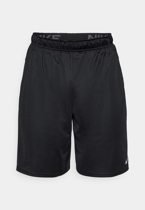 Mustat urheilushortsit, joissa on elastinen vyötärö ja 'NIKE' -logo. Valmistettu kevyestä kankaasta, jolla on sileä pinta, eikä taskuja.