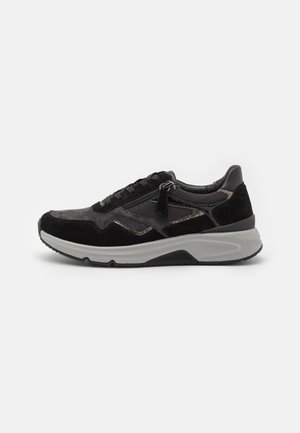 Black suede sneaker with mesh accents, featuring a textured lace-up front, metallic zipper detail, and a contrasting gray rubber sole.
