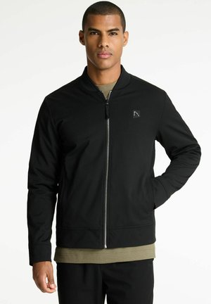 Svart zip-up bomberjacka med en mjuk textur, ribbad krage och sidofickor. Har en liten logo på bröstet.