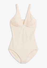 Maillot de bain une pièce beige clair avec un décolleté en V profond, des bretelles fines ajustables et un tissu doux et extensible. Texture lisse sans motifs ni accents.
