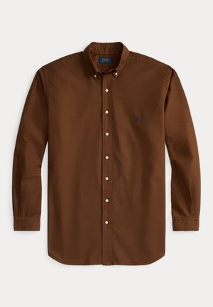 Brown long-sleeve button-up shirt made of cotton, featuring a classic collar, white buttons, and a small blue logo on the left chest.