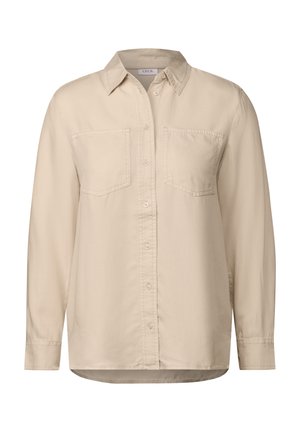 Camicia beige con bottoni, colletto, maniche lunghe e due tasche sul petto. Realizzata in un materiale morbido con una texture liscia. Orlo dritto.