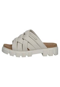 Closed-toe slide sandal with a woven design in light beige, featuring a thick rubber sole with ridges and a textured footbed.