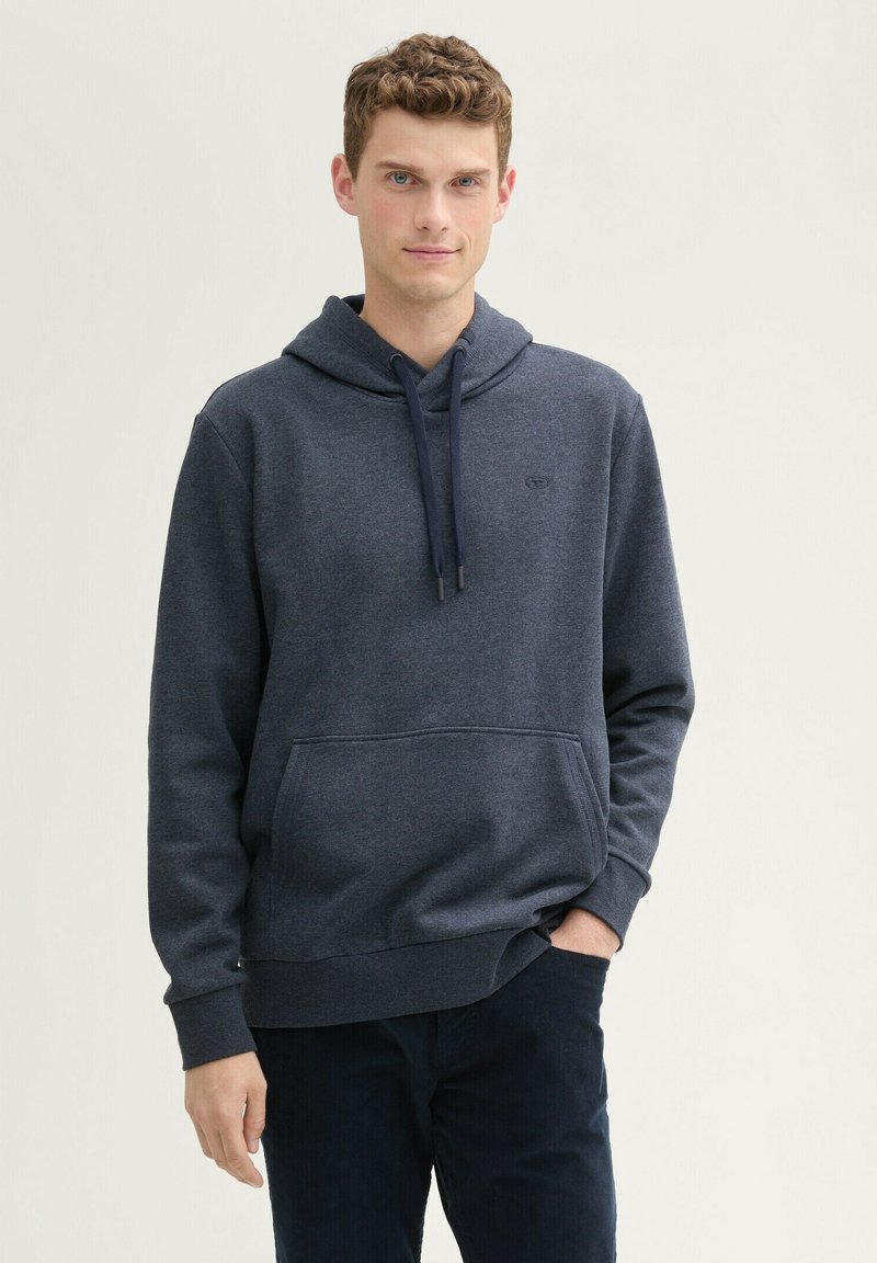 Felpa blu navy con cappuccio e cordino, tasca frontale e polsini a coste. Realizzata in tessuto morbido, presenta un piccolo logo sul petto.