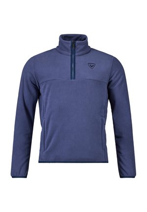 Sudadera de forro polar azul marino con cuello alto, cierre de media cremallera en el frente y logo en el pecho. Textura suave, diseño ajustado y bolsillos laterales.