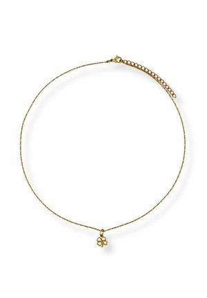 Delicate gold chain necklace with a small four-leaf clover charm and an adjustable link clasp on a white background.