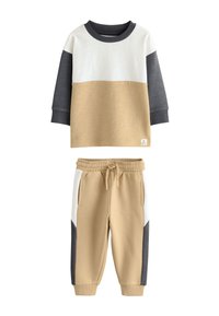 Two-piece set featuring a long-sleeve top in beige, white, and gray, with matching beige pants that have side pockets and color-blocked accents.