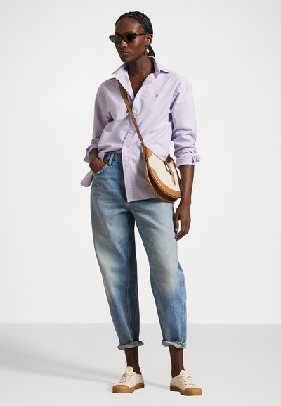 Lavender button-up shirt, light blue baggy jeans, and light sneakers. Pairing with cat-eye sunglasses and a brown crossbody bag.