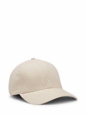 Beige baseballpet met gebogen klep, stoffen textuur en "BOSS" geborduurd in het midden aan de voorkant.