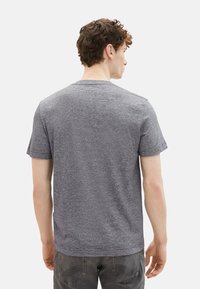 Gray striped t-shirt with short sleeves and a crew neck, made of soft fabric. Back view shows simple design and smooth texture.