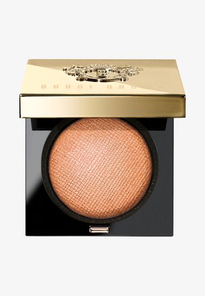 Bobbi Brown highlighter in a black compact. Features a textured champagne-colored powder, topped with a gold lid embossed with logo.